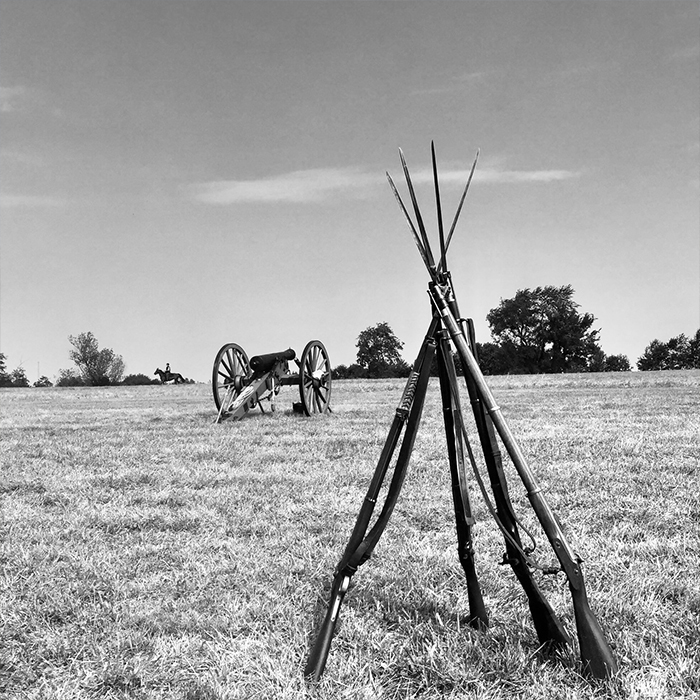 Pile of historical guns in front of a canyon